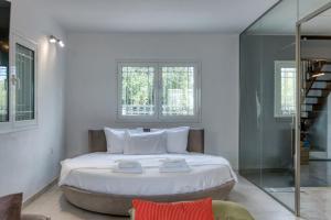 a bedroom with a large bed and a glass shower at Sahara Blanc Villa - Private Pool - Loft Space in Spiliazéza +33 photos