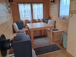 a wooden room with a table and a window at Tiny Mélisse in Leimbach