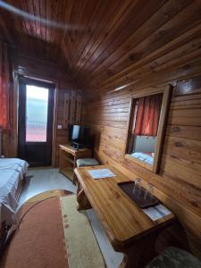 a room with a wooden cabin with a sink in it at Casa Elena - Resort & SPA in Voronet