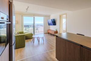 a kitchen and living room with a view of the ocean at Old Town 63 Luxury Residence in Paphos