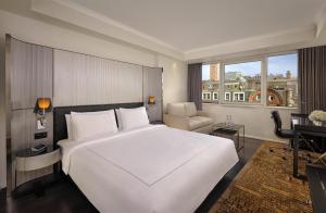 a bedroom with a large white bed and a desk at Park Plaza London Victoria in London +69 photos