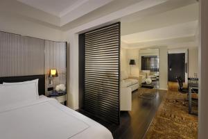 a bedroom with a bed and a living room at Park Plaza London Victoria in London