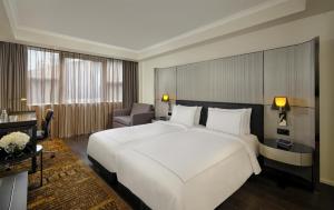 a large white bed in a hotel room at Park Plaza London Victoria in London