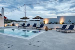a patio with chairs and a swimming pool at Sahara Blanc Villa - Private Pool - Loft Space in Spiliazéza
