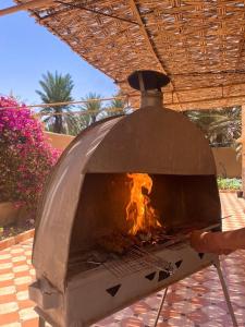 a pizza oven with a fire inside of it at Villa Palm Desert- your Private Stay with AC, Fast WiFi & Parking in Erfoud