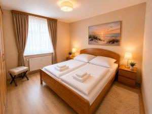 a bedroom with a large bed and a window at Seebad Ahlbeck - Haus MIRAMAR in Heringsdorf