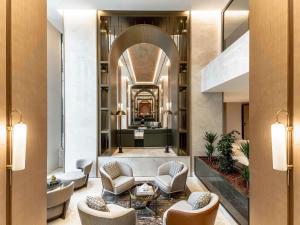 a lobby of a hotel with chairs and a living room at Mövenpick Istanbul Old Town in Istanbul +234 photos