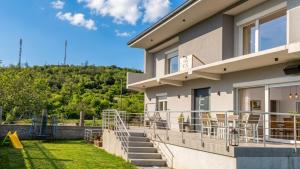 a house with a balcony with a playground at Vila V & S in Star Dojran