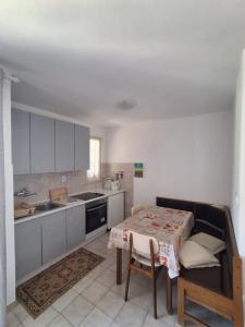 a kitchen with a table and a table and a table and a kitchen at Apartments and Studios Vinko Matić in Rab