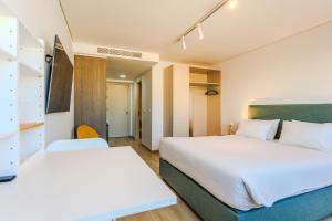 a hotel room with two beds and a hallway at Old Town 63 in Paphos