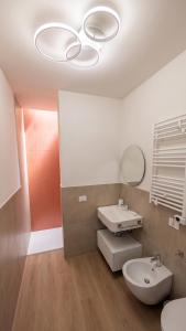 a bathroom with a sink and a toilet and a mirror at Sfreg Suites Magenta - Camere e B&B in Magenta +56 photos