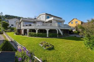 a large house with a large yard at Modern Arctic Apartment in Tromsø +2 photos