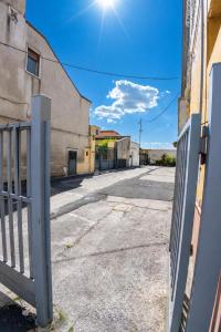 an empty street with a gate in front of a building at Fuoribinario B&B in San Felice a Cancello