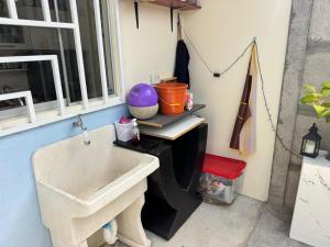 a bathroom with a sink next to a window at Alojamiento en Chilca in Salinas