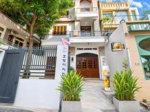 a building with a door and plants in front of it at Uh Homestay Thảo Điền in Ho Chi Minh City