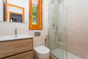a bathroom with a shower and a toilet and a sink at Paradise Residence Garden in SantʼAlessio Siculo +42 photos