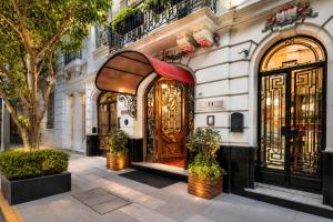 a building with a wooden door on a street at Duque Hotel Boutique & Spa in Buenos Aires