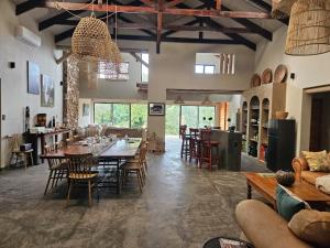 a large living room with a table and chairs at Nkinga River Lodge in Balule Game Reserve
