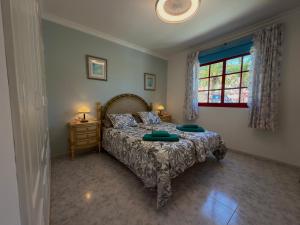 a bedroom with a bed with two green pillows on it at Playa del Cura - Beachside Retreat in Playa del Cura +72 photos