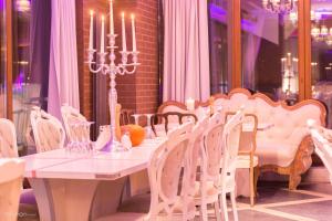 a table with chairs and a white table with candles at Hotel Ramka & Restaurant & Wine Bar in Poznań +37 photos