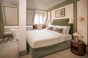 a bedroom with a large bed and a bath tub at King Street Townhouse Hotel & Spa in Manchester +69 photos