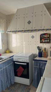 a kitchen with a stove top oven in a kitchen at Casa La Ferrata in Jimera de Líbar +11 photos