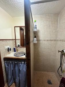 a bathroom with a sink and a shower at Casa La Ferrata in Jimera de Líbar