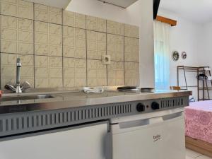 a kitchen with a sink and a stove at Studios Fedra in Potamiá