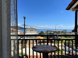a table on a balcony with a view of the ocean at Studios Fedra in Potamiá +31 photos
