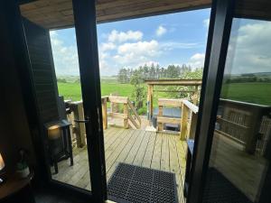 a view from the front door of a deck at The Truck with private hot tub -Garvagh retreats in Ballynameen