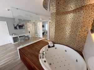 a large bathroom with a tub in a room at Kalyon Cesme in Çeşme +32 photos