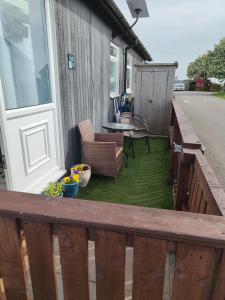 a deck with a table and chairs on a house at ElE G Holiday let's Bridlington in Bridlington