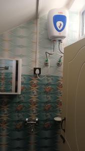 a bathroom with a sink and a toilet at Mist N Mountain in Kurseong