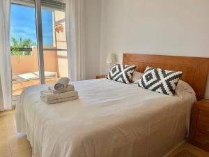 a bedroom with a bed with a view of the ocean at Condado de Alhama la isla 7SV2D in El Romero