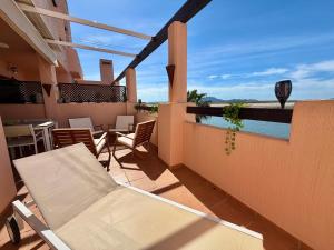 a balcony with a table and chairs and a pool at Condado de Alhama la isla 7SV2D in El Romero