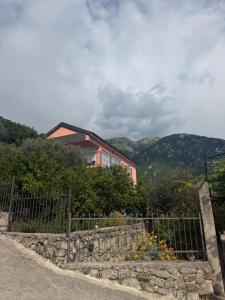 a house on a hill with a fence at Ostojic lux apartman in Kotor