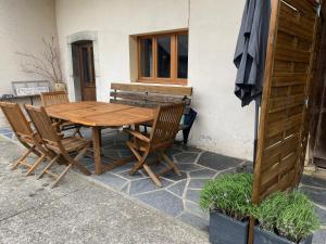 a wooden table and chairs sitting next to a bench at La ferme d'Auguste in Thorens-Glières +16 photos