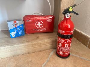 a red fire hydrant sitting next to a box at Casa via veneto in Carbonia