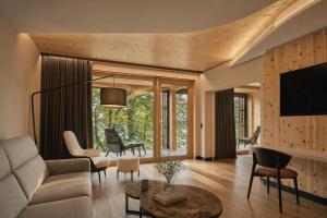 a living room with a couch and a tv at Buff Medical Resort Konstanz in Konstanz