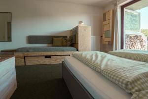 a bedroom with two beds and a couch at Harz BnB Werkmeister in Sankt Andreasberg