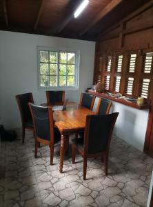 a dining room with a wooden table and chairs at Kaiche in Trafalgar