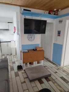 a living room with a flat screen tv on a wall at ElE G Holiday let's Bridlington in Bridlington +2 photos