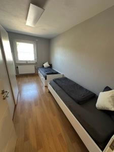 a room with two beds and a window at Haselbach Living in Ehekirchen
