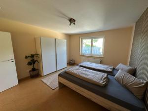 a bedroom with a bed and a white cabinet at Haselbach Living in Ehekirchen