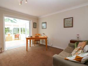 a living room with a table and a couch at Meadowcroft in Watchet