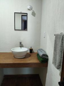 a bathroom with a white sink and a mirror at Mi Casa Morelia in Morelia