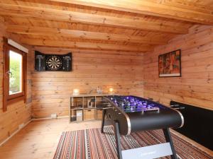 a game room in a log cabin with a dart board at Meadowcroft in Watchet