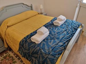 a bedroom with a bed with towels on it at 4 Seasons studio in Marinha das Ondas