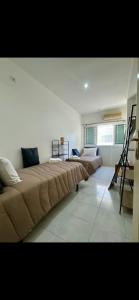 a large room with two beds and a staircase at Dolls House in Lagos