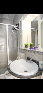 a bathroom with a white sink and a mirror at Dolls House in Lagos